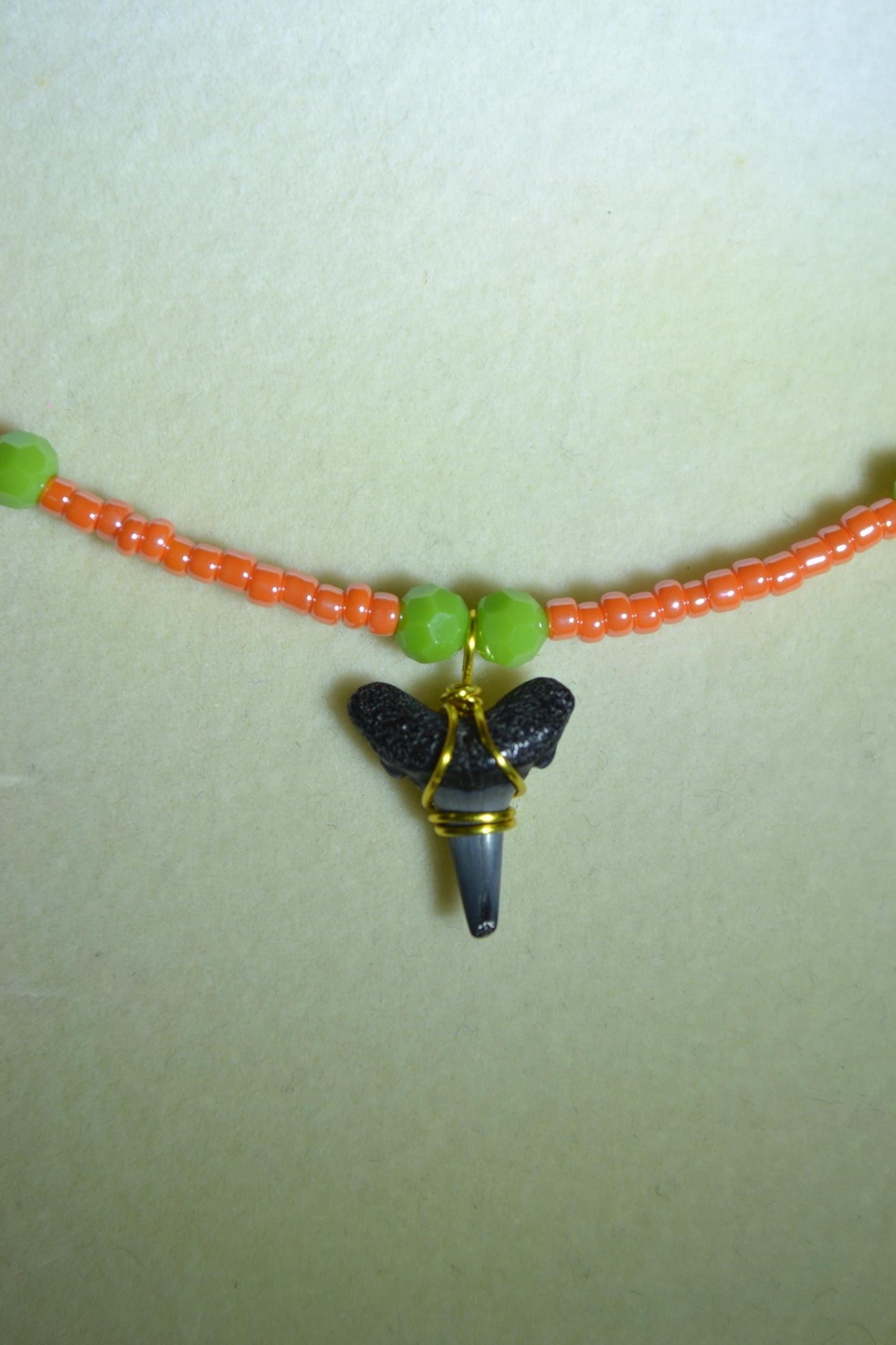Wire wrapped sharks tooth beaded necklace. Coral and green