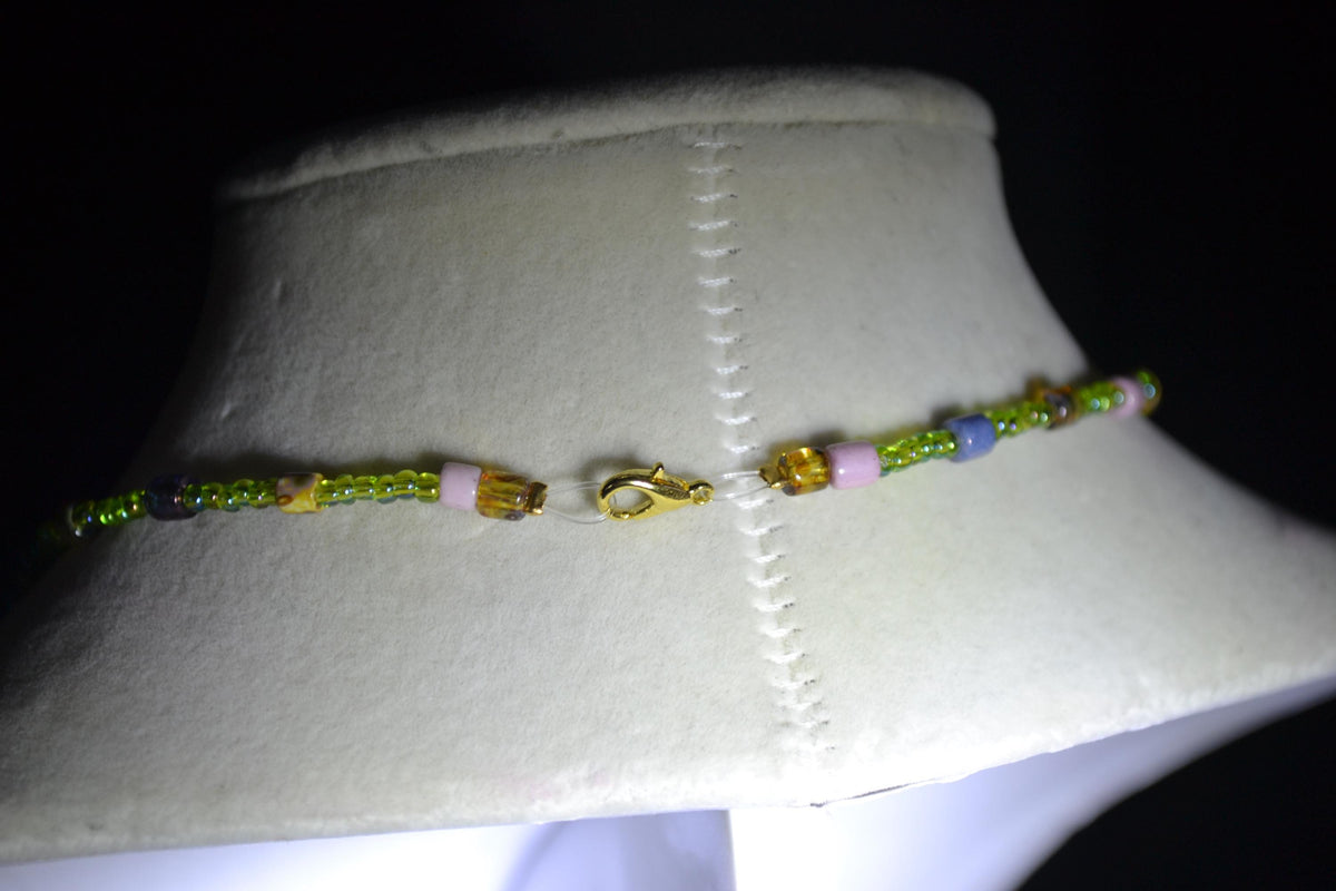 Gold Palm pendant glass bead necklace. Green and rainbow