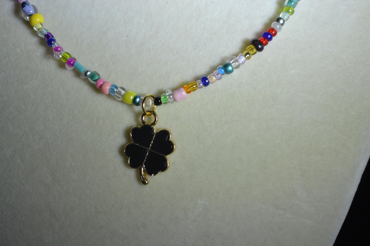 Black clover pendant glass bead necklace. Rainbow