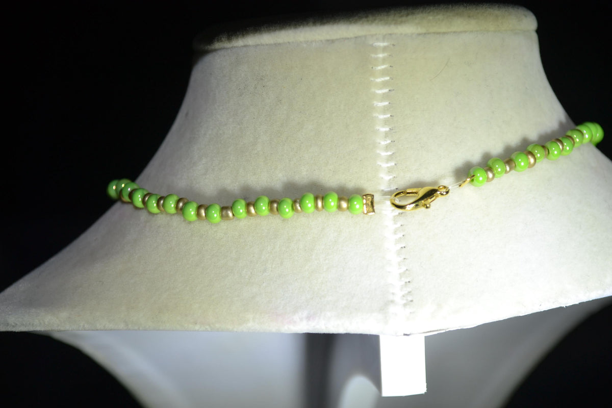 Wooden Monstera pendant glass bead necklace. Green and gold