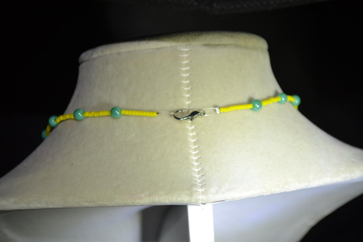 Silver sun pendant glass bead necklace. Yellow and turquoise