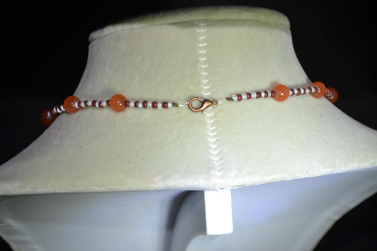 Brass bubbles pendant glass bead necklace. Orange, white, and brown