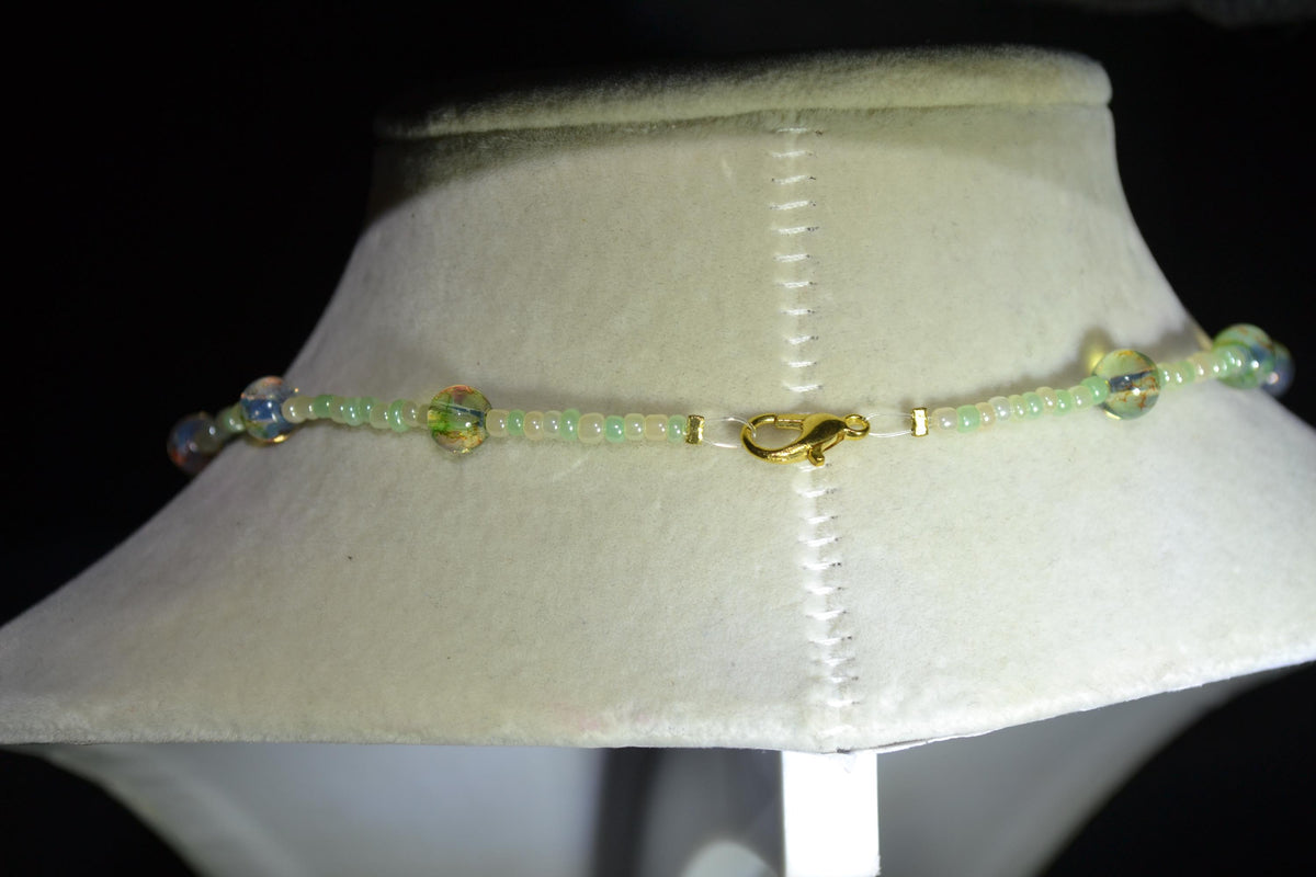 Gold Marijuana Leaf pendant glass bead choker. Pearl white, green, and topaz