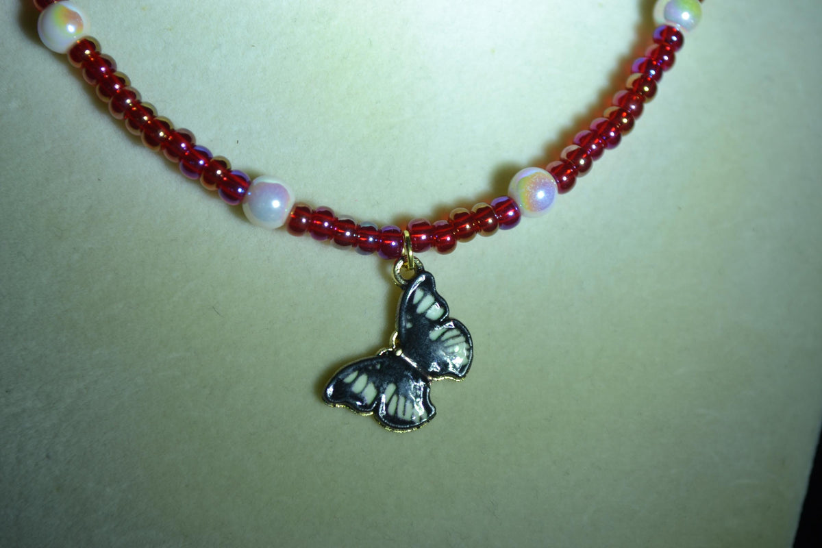 Black Butterfly pendant glass bead necklace. Pearl and red