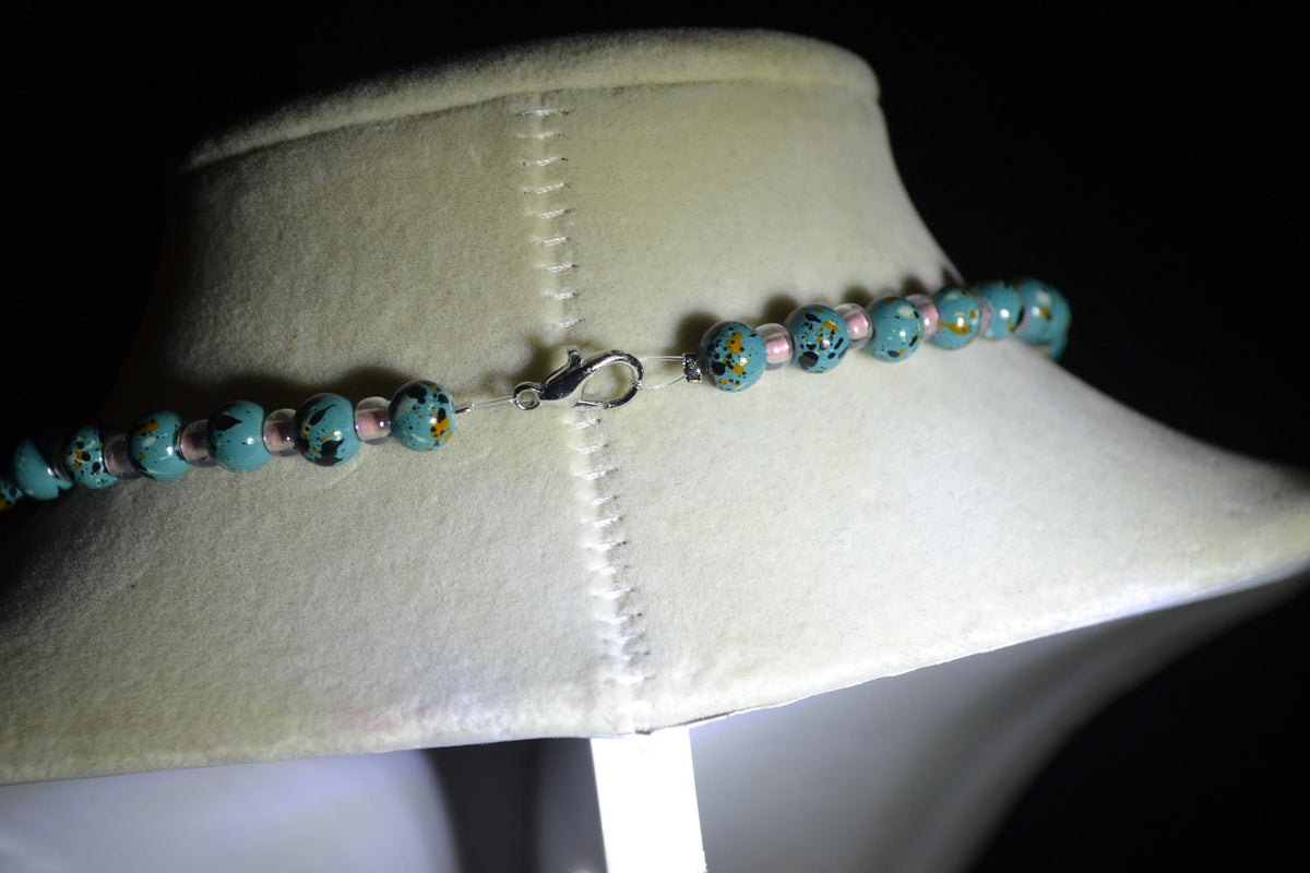 Iridescent philodendron pendant glass bead necklace. Turquoise and pink