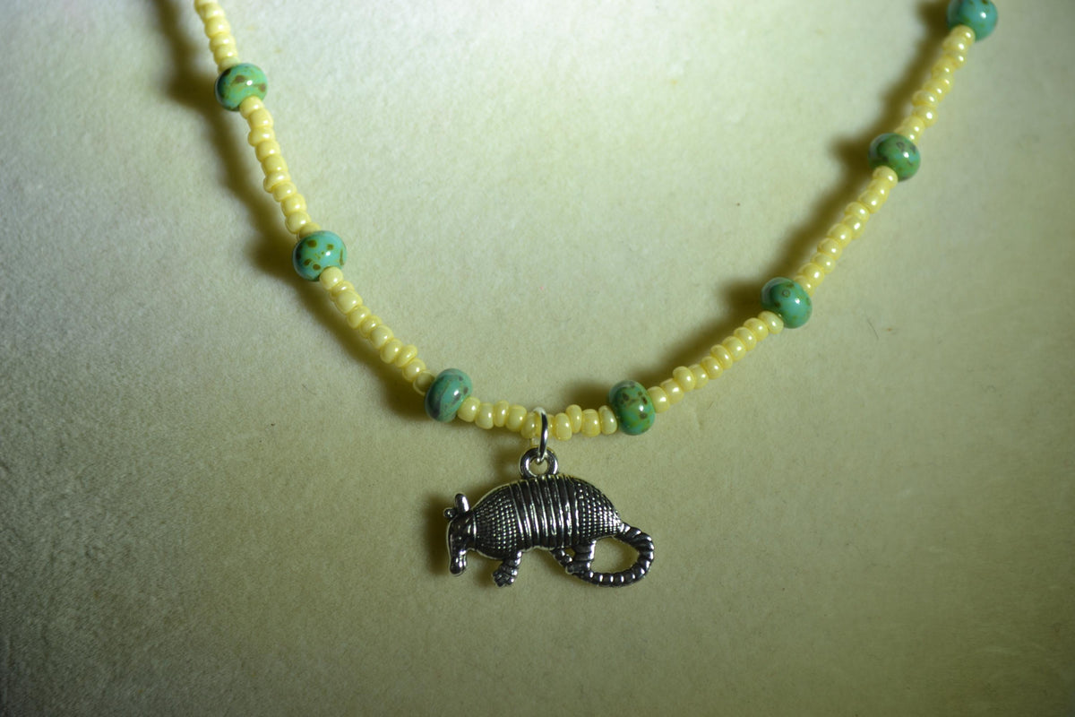 Silver Armadillo pendant glass bead necklace. Yellow and turquoise