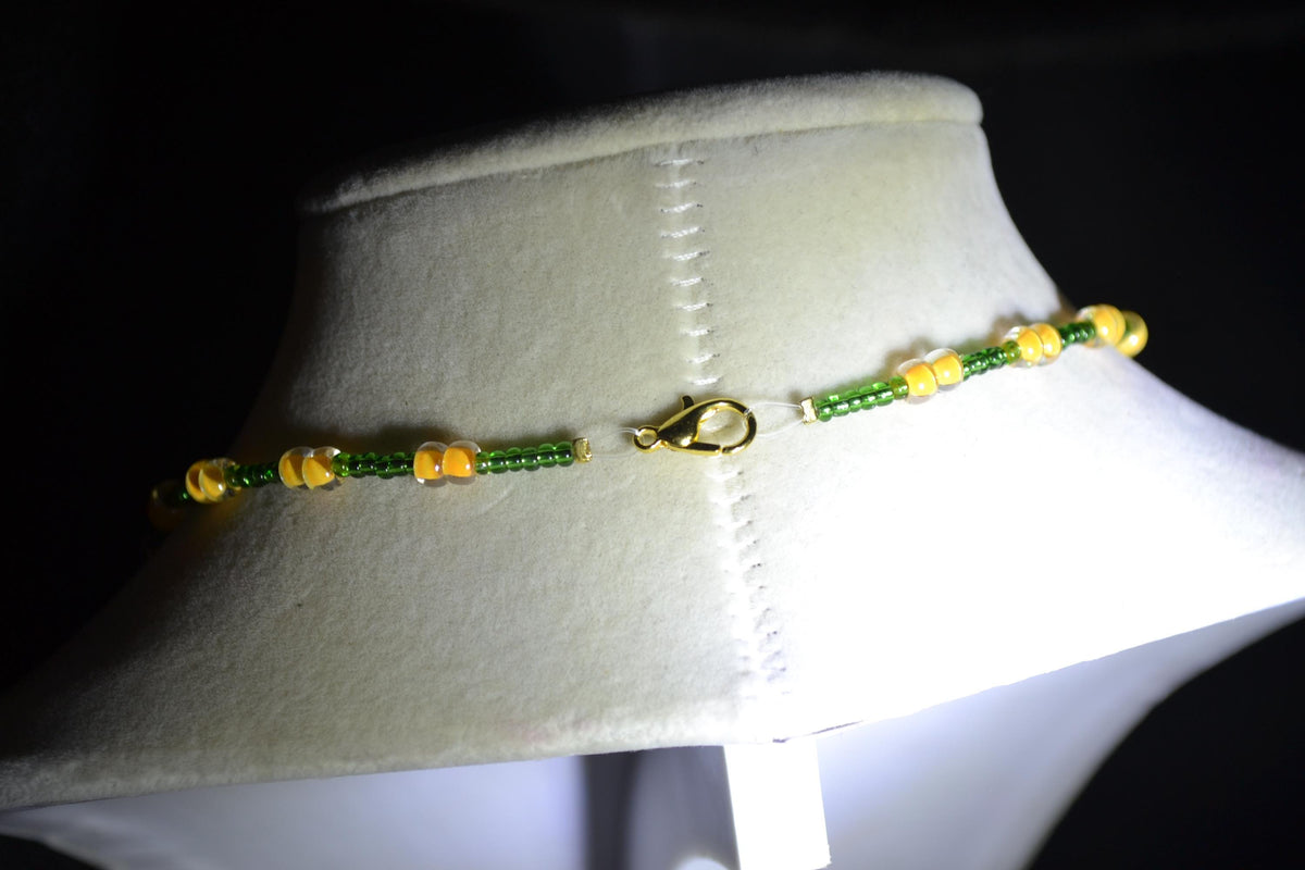 Gold alligator pendant glass bead necklace. Green and yellow