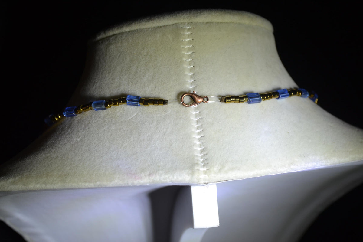 Bronze Sand dollar pendant glass bead necklace. Blue and bronze