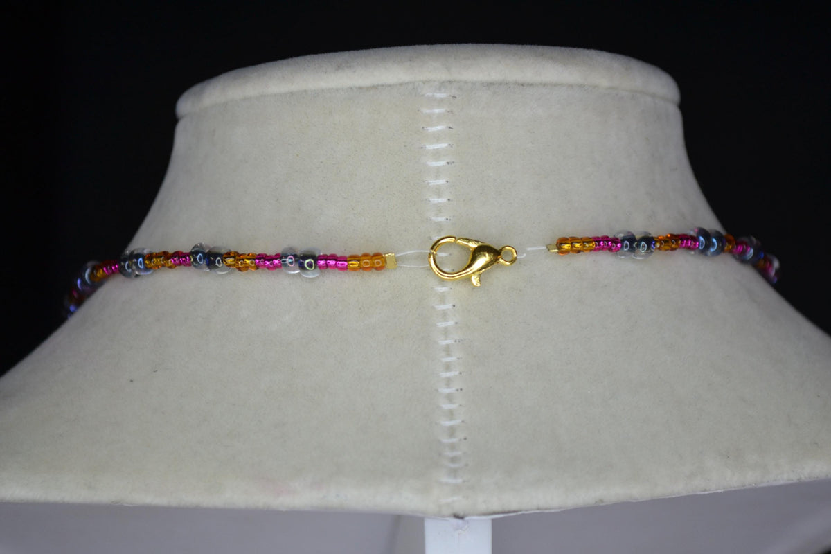 Bronze gold flower pendant glass bead necklace. Brown, Fuschia, and black