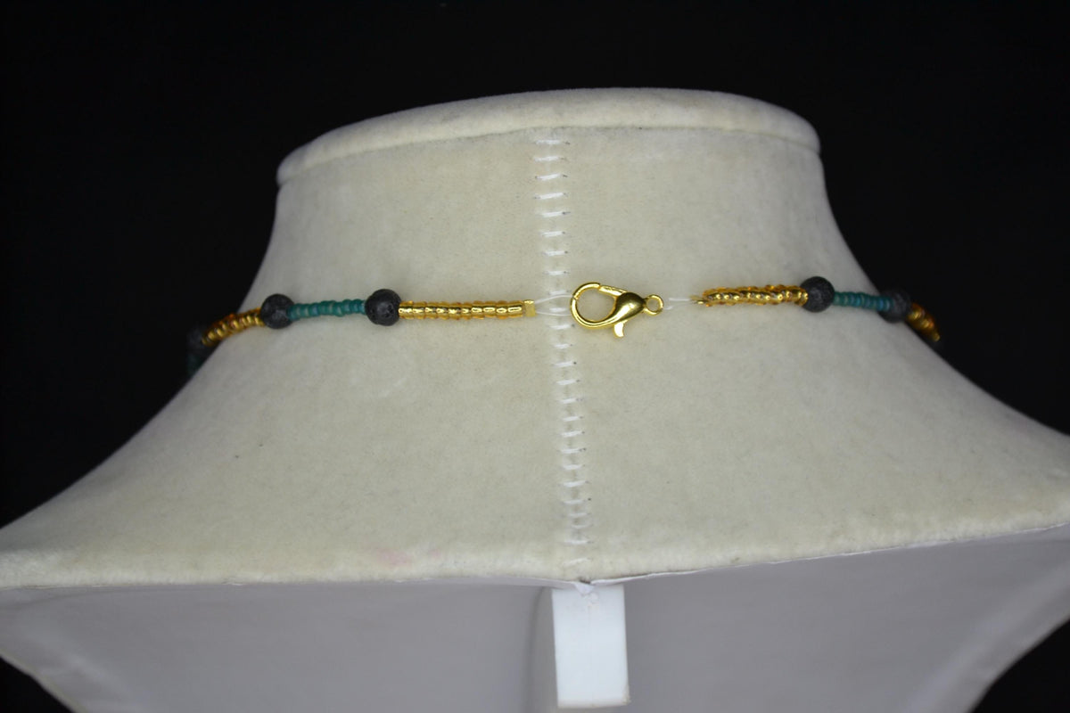 Gold Jaguar pendant glass bead necklace. Teal, gold, and lava rock
