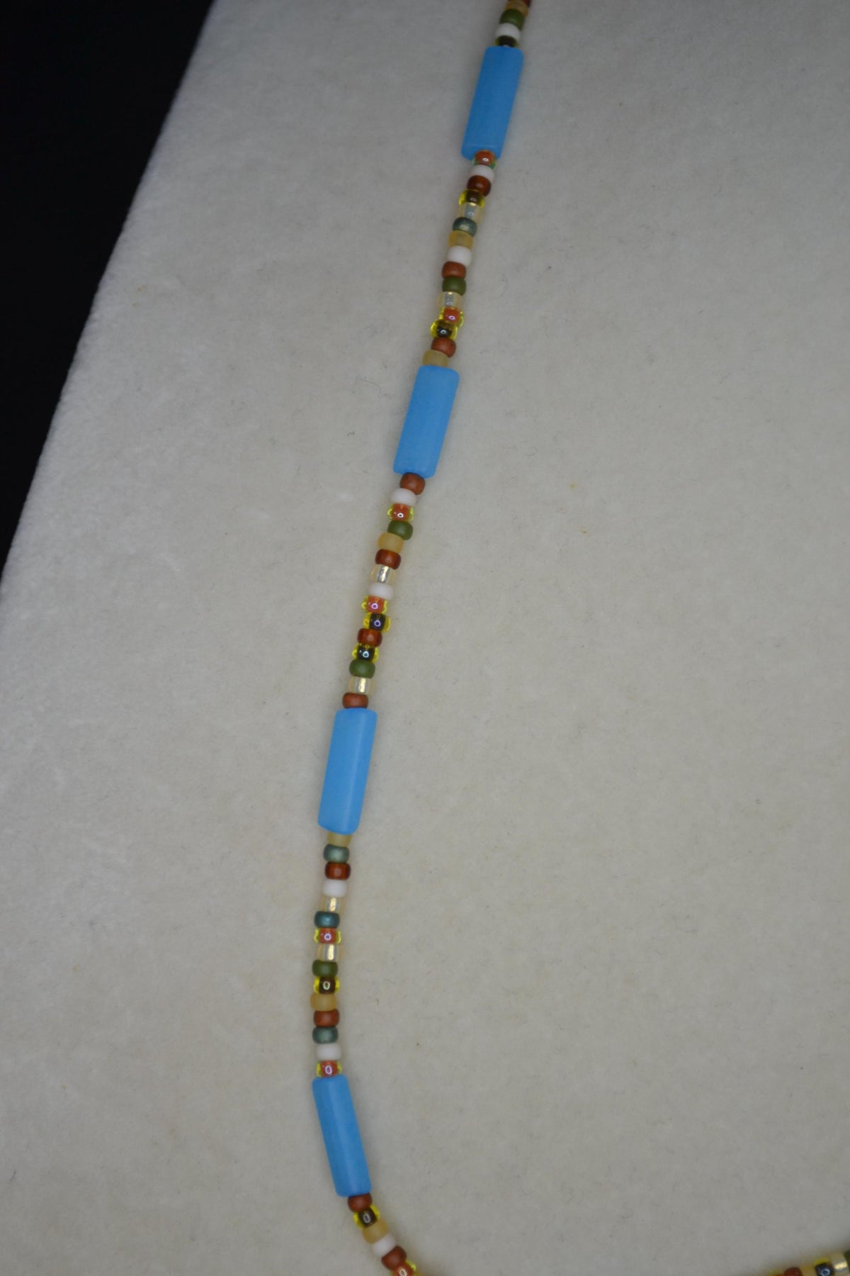 Silver sun pendant glass bead necklace. Matte blue and forest colors