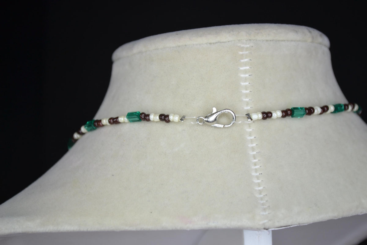 Silver Pelican pendant glass bead necklace. Teal, brown, and white