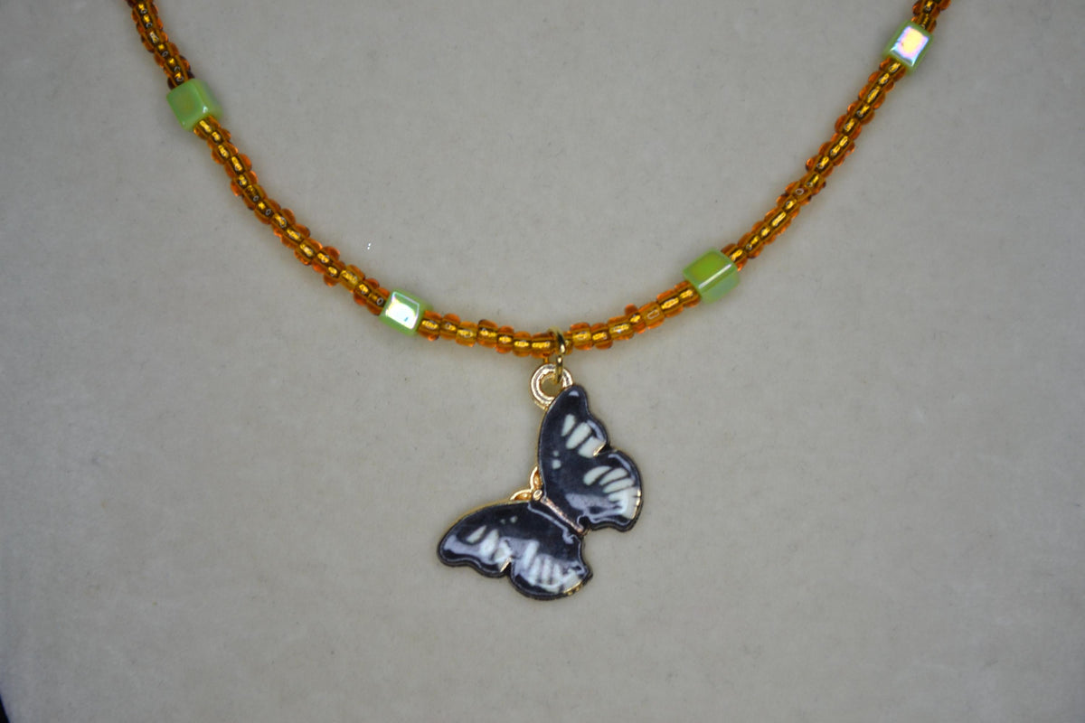 Black Butterfly pendant glass bead necklace. Brown and iridescent green