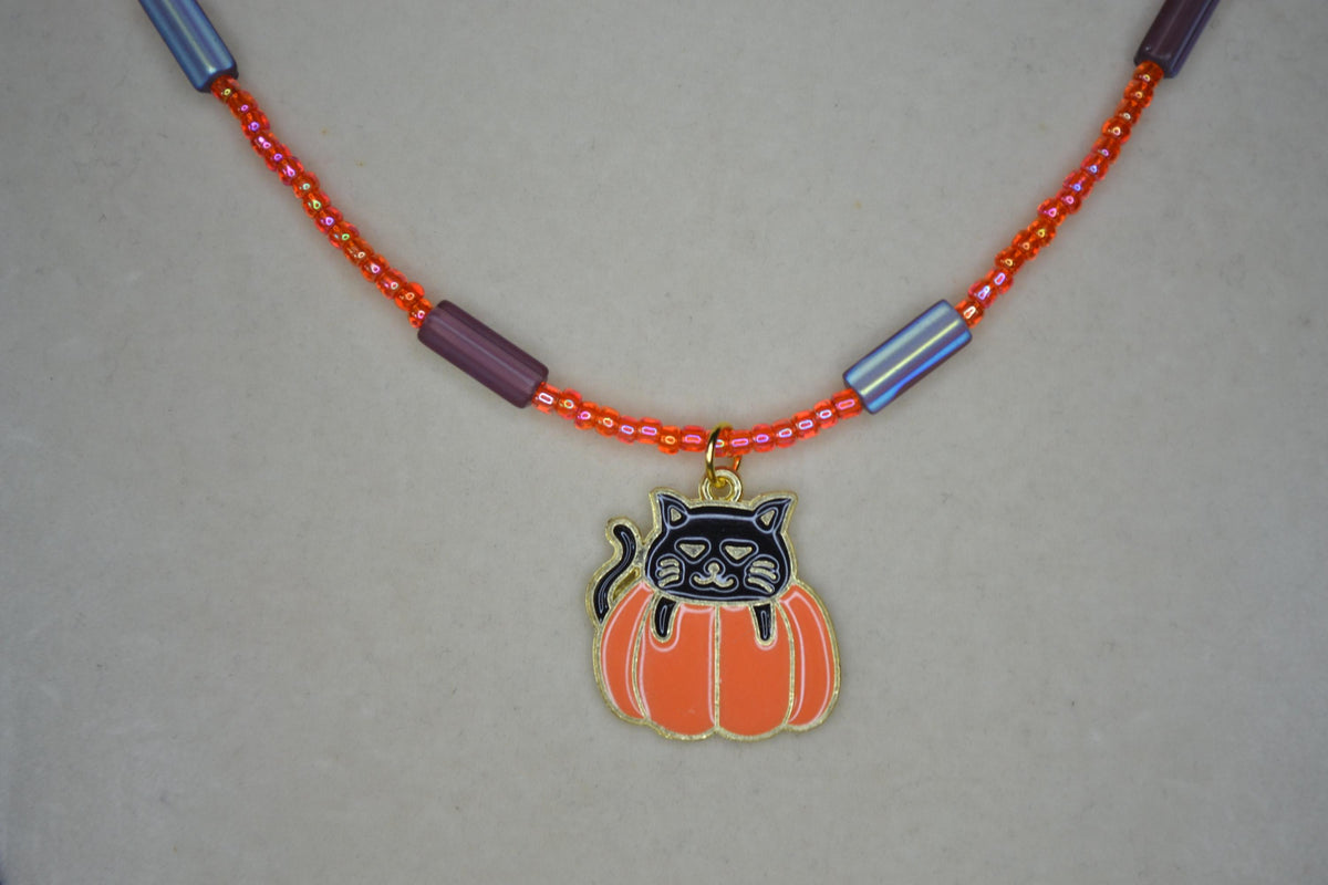 Black cat in pumpkin pendant glass bead choker. Orange and metallic amethyst