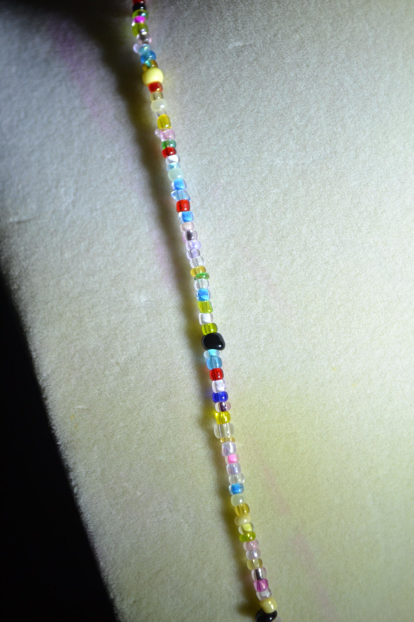 Multicolor glass bead necklace. Feather pendant