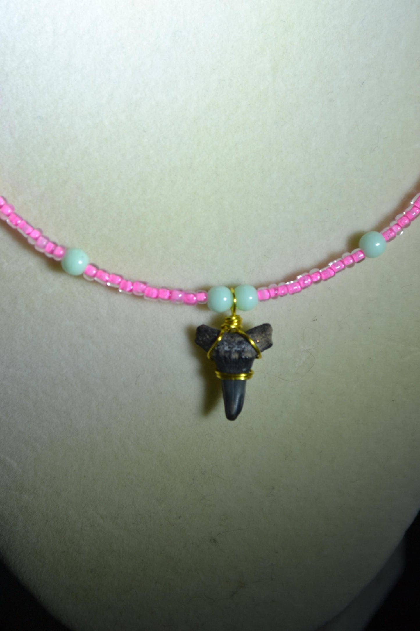 Wire wrapped sharks tooth pendant beaded necklace. Pink and green