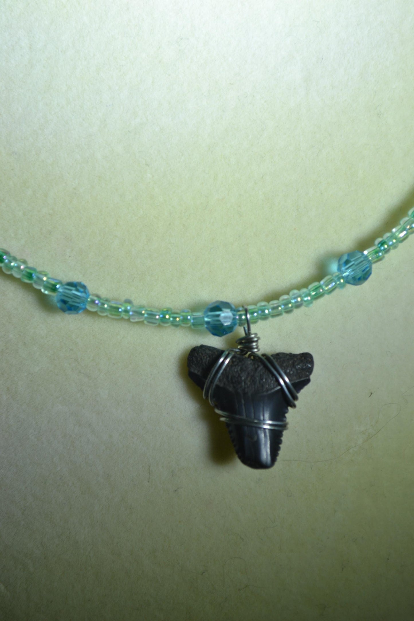 Wire wrapped sharks tooth beaded necklace. Blues