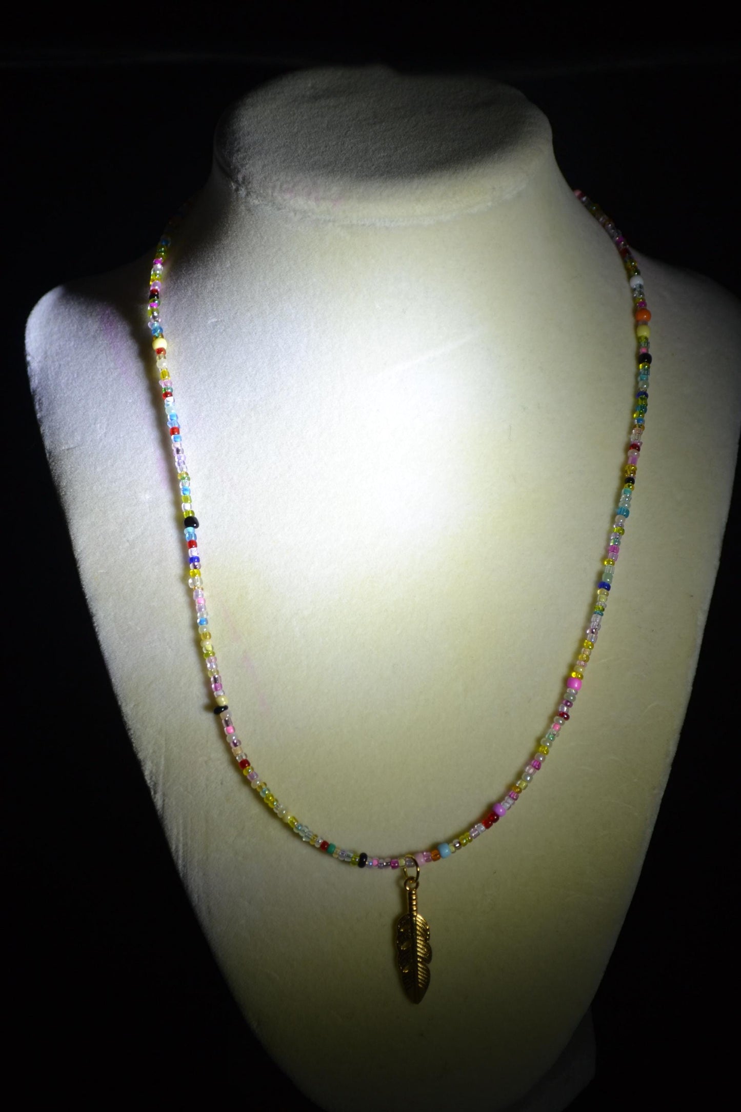 Multicolor glass bead necklace. Feather pendant