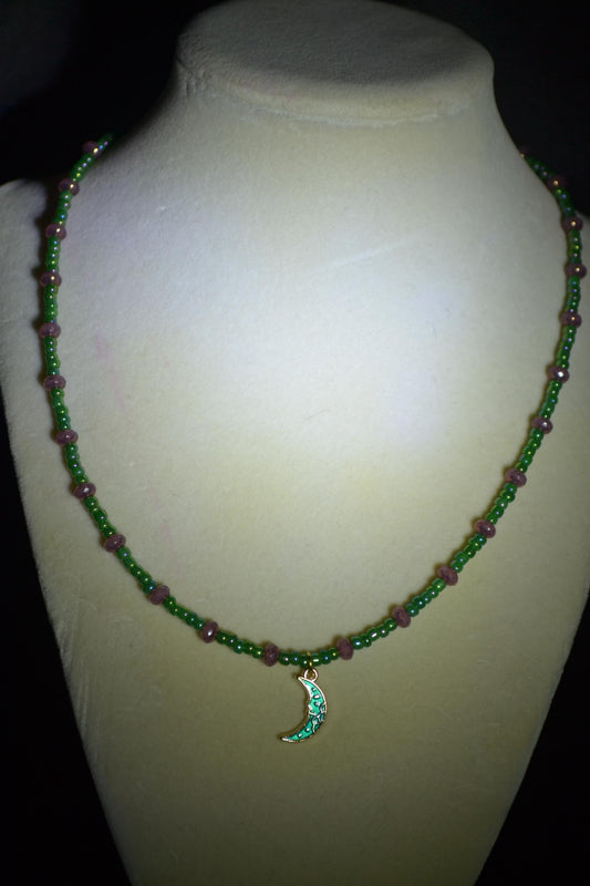 Green moon pendant glass bead necklace. Purple and green