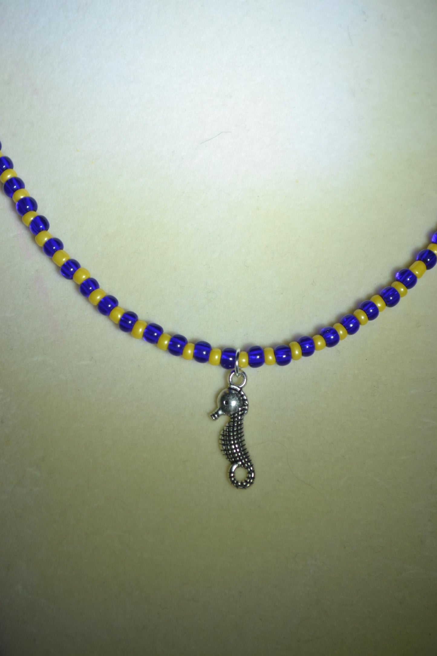 Seahorse pendant glass bead necklace. Blue and yellow