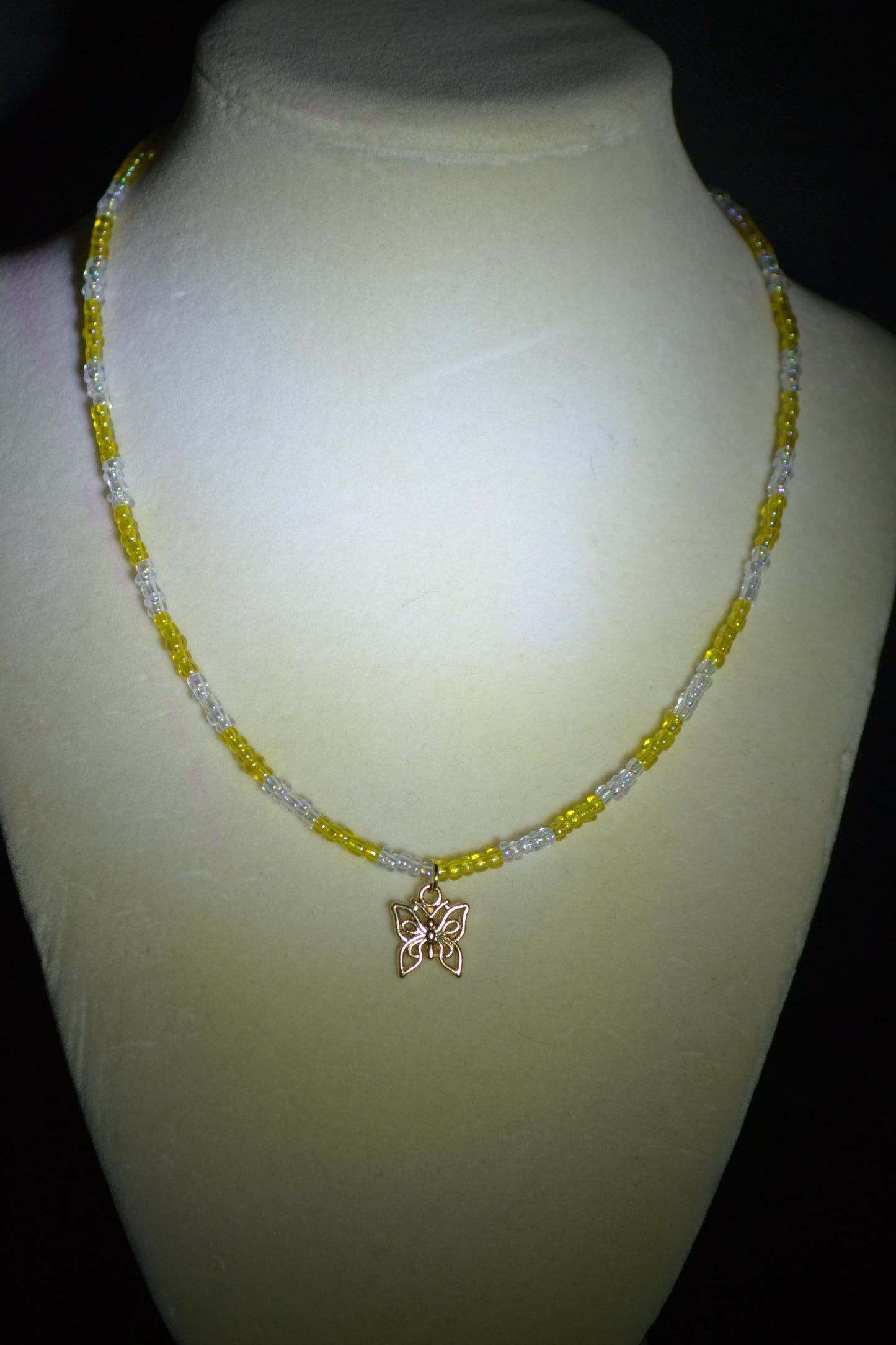 Butterfly pendant glass bead necklace. Yellow and iridescent