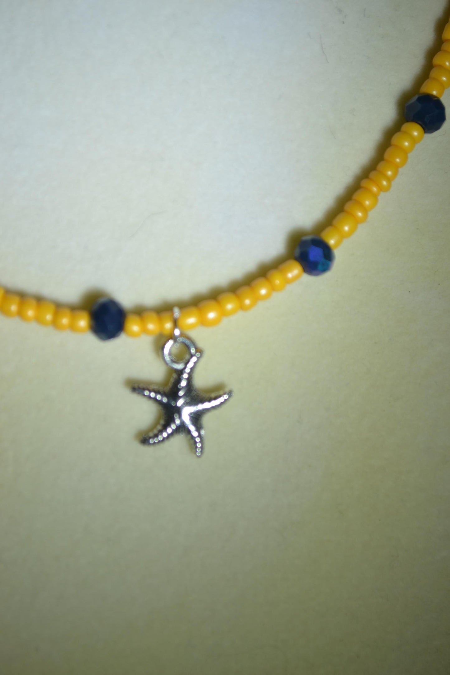 Starfish pendant glass bead choker. Tangerine and iridescent black