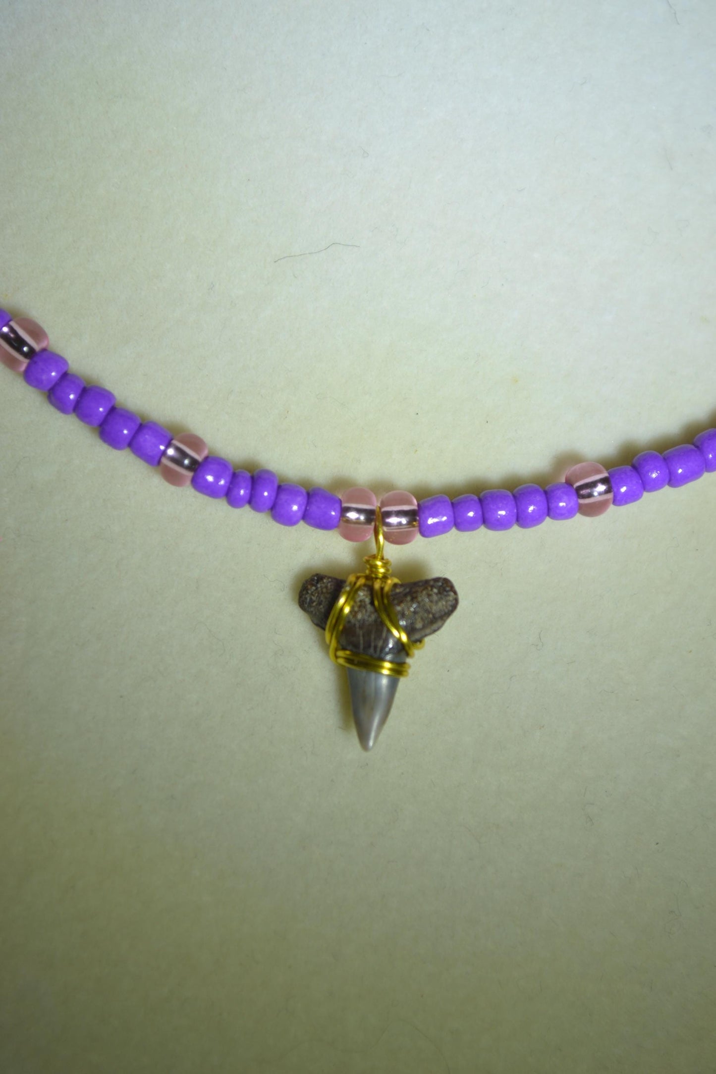 Wire wrapped sharks tooth beaded necklace. Purple and pink