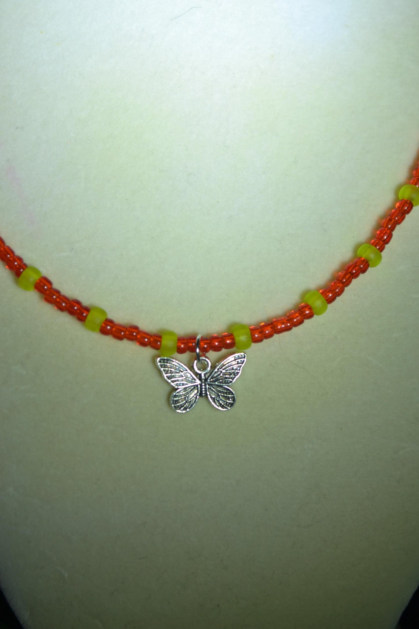 Butterfly pendant glass bead necklace. Red and green