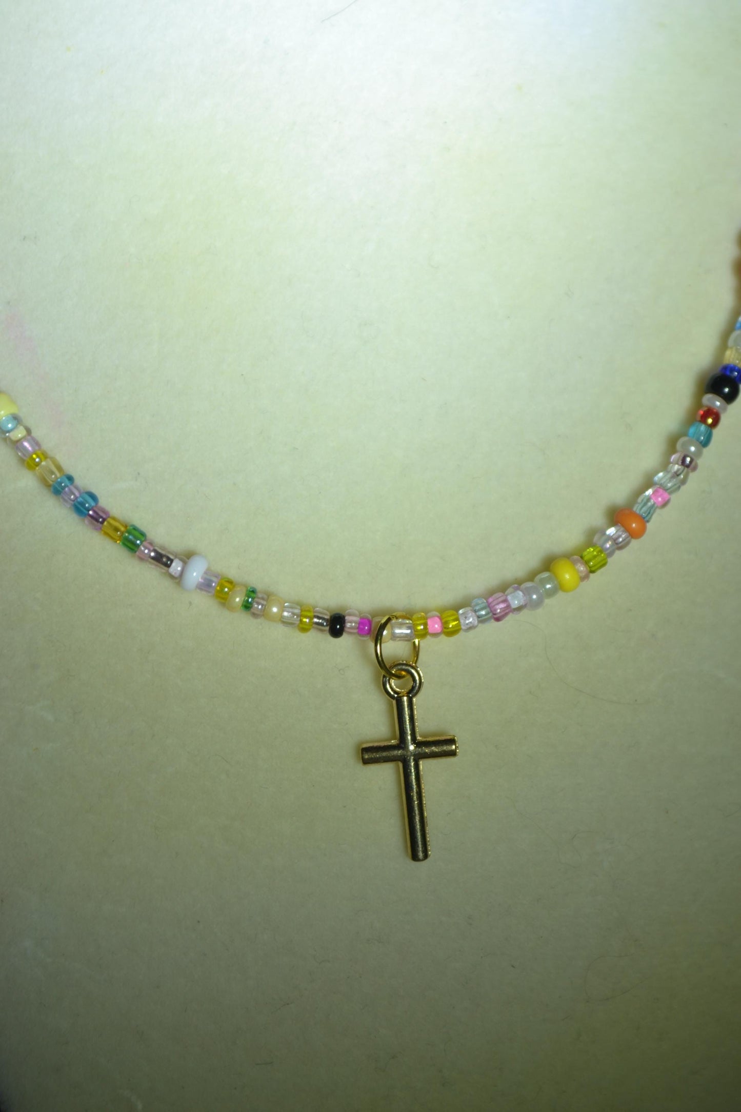 Cross pendant glass bead necklace. Rainbow