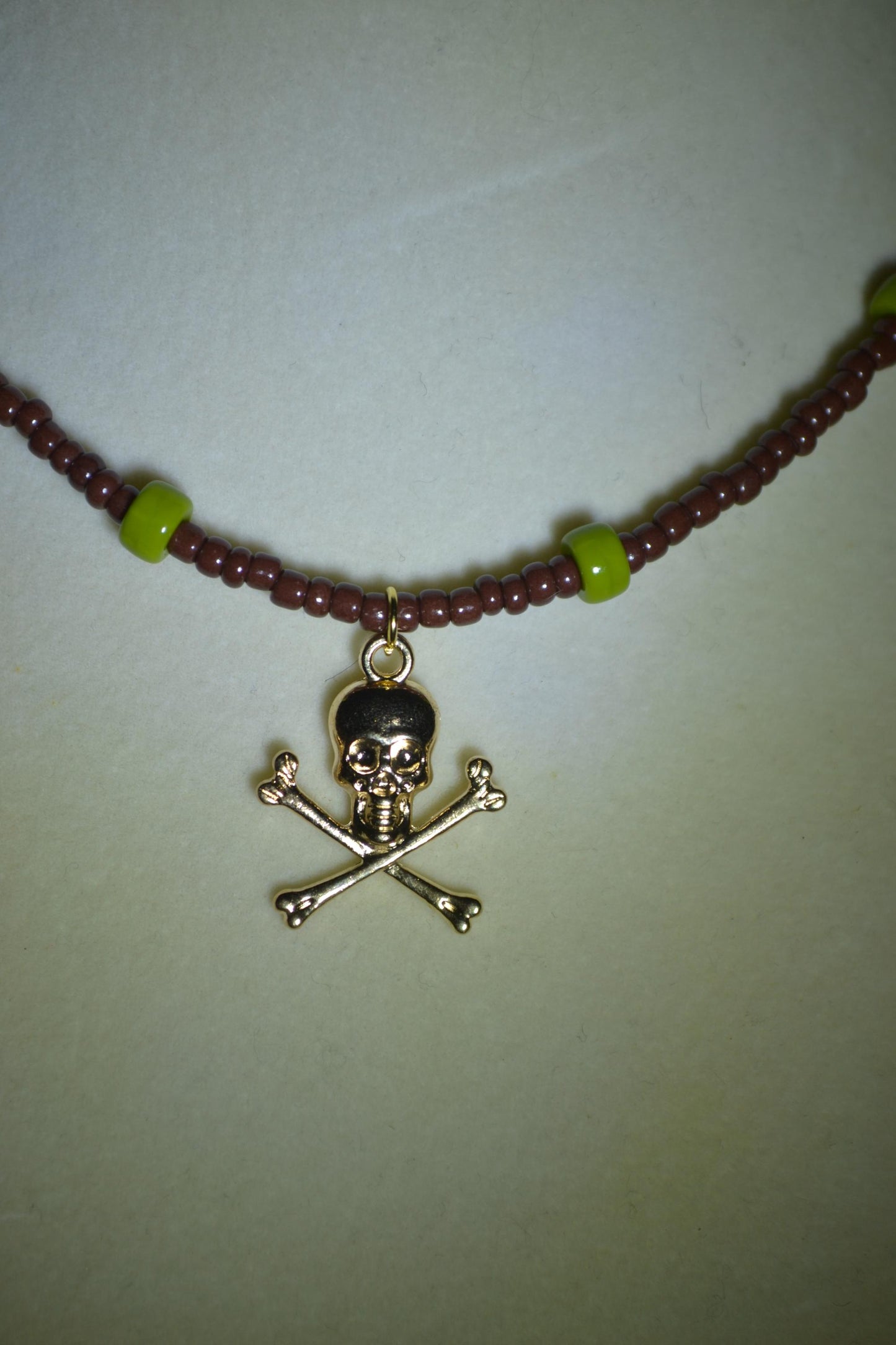 Skull and bones pendant glass bead choker. Brown and olive