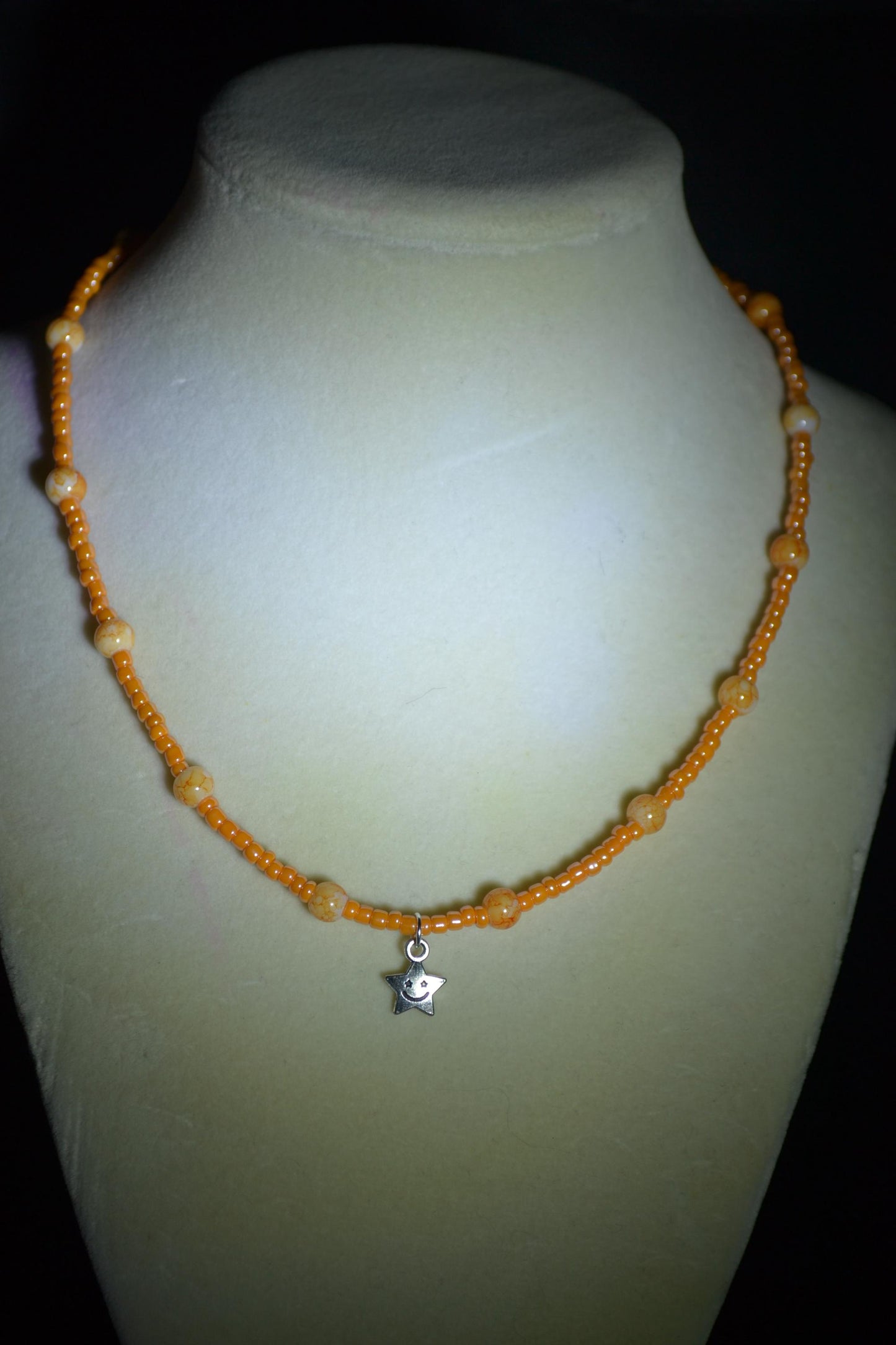 Smiling star pendant glass bead necklace. Mixed oranges