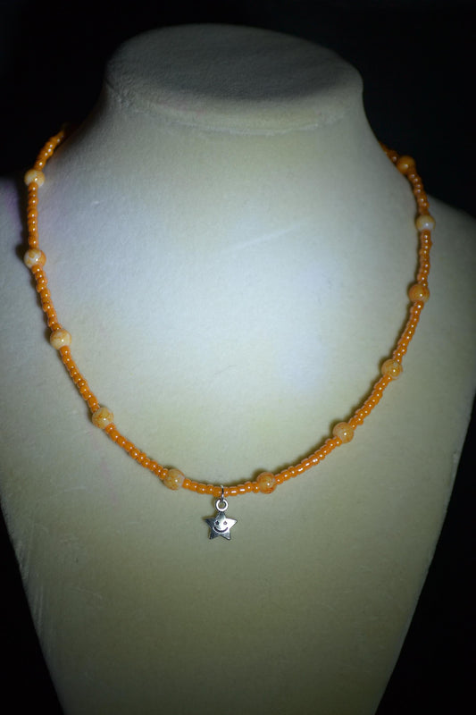 Smiling star pendant glass bead necklace. Mixed oranges