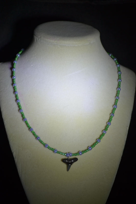 Wire wrapped sharks tooth beaded necklace. Purple and green