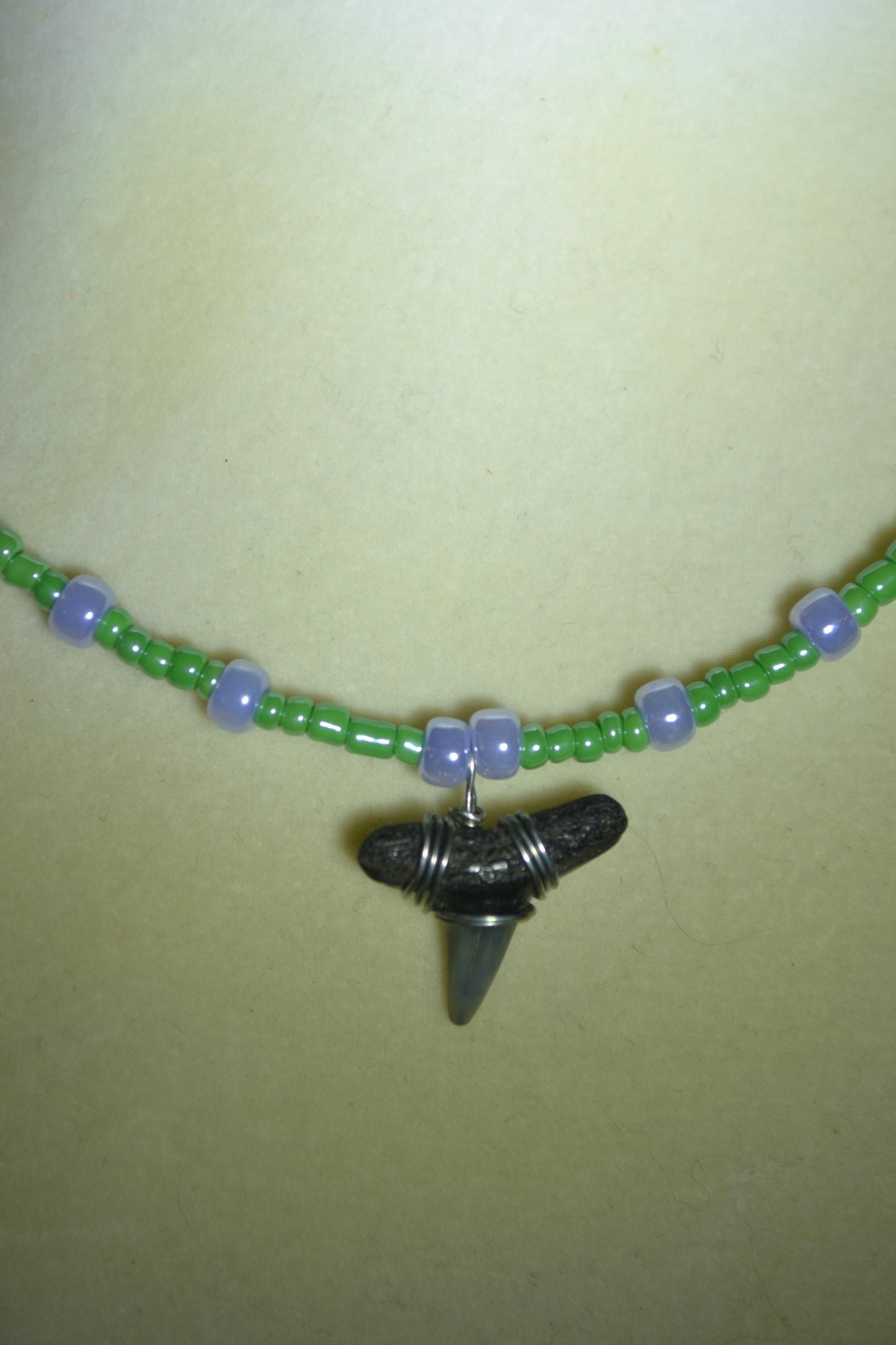 Wire wrapped sharks tooth beaded necklace. Purple and green