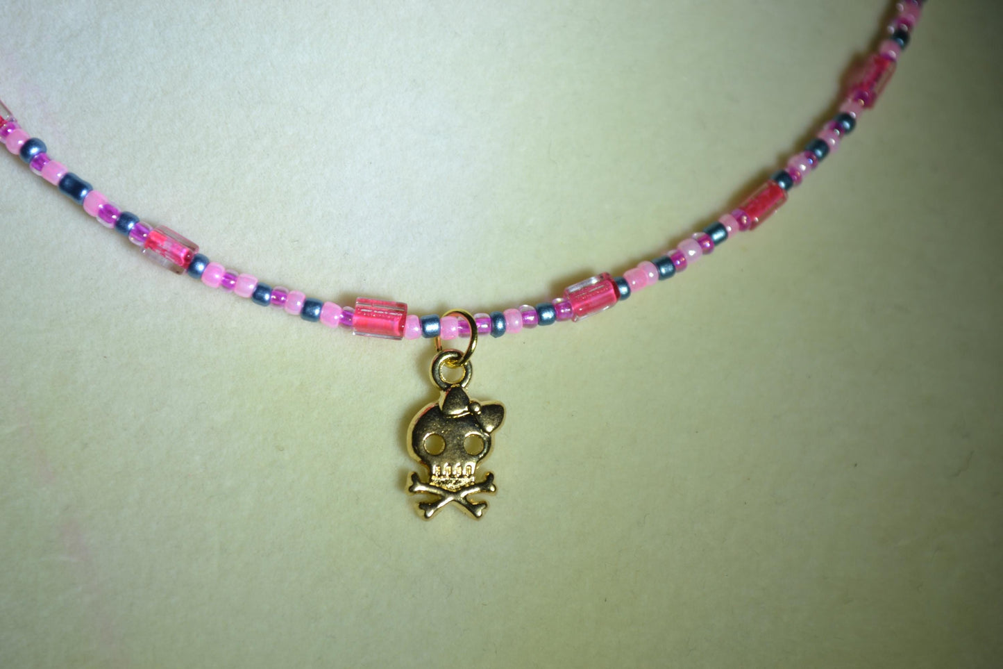 Skull and bones pendant glass bead choker. Pink and blue