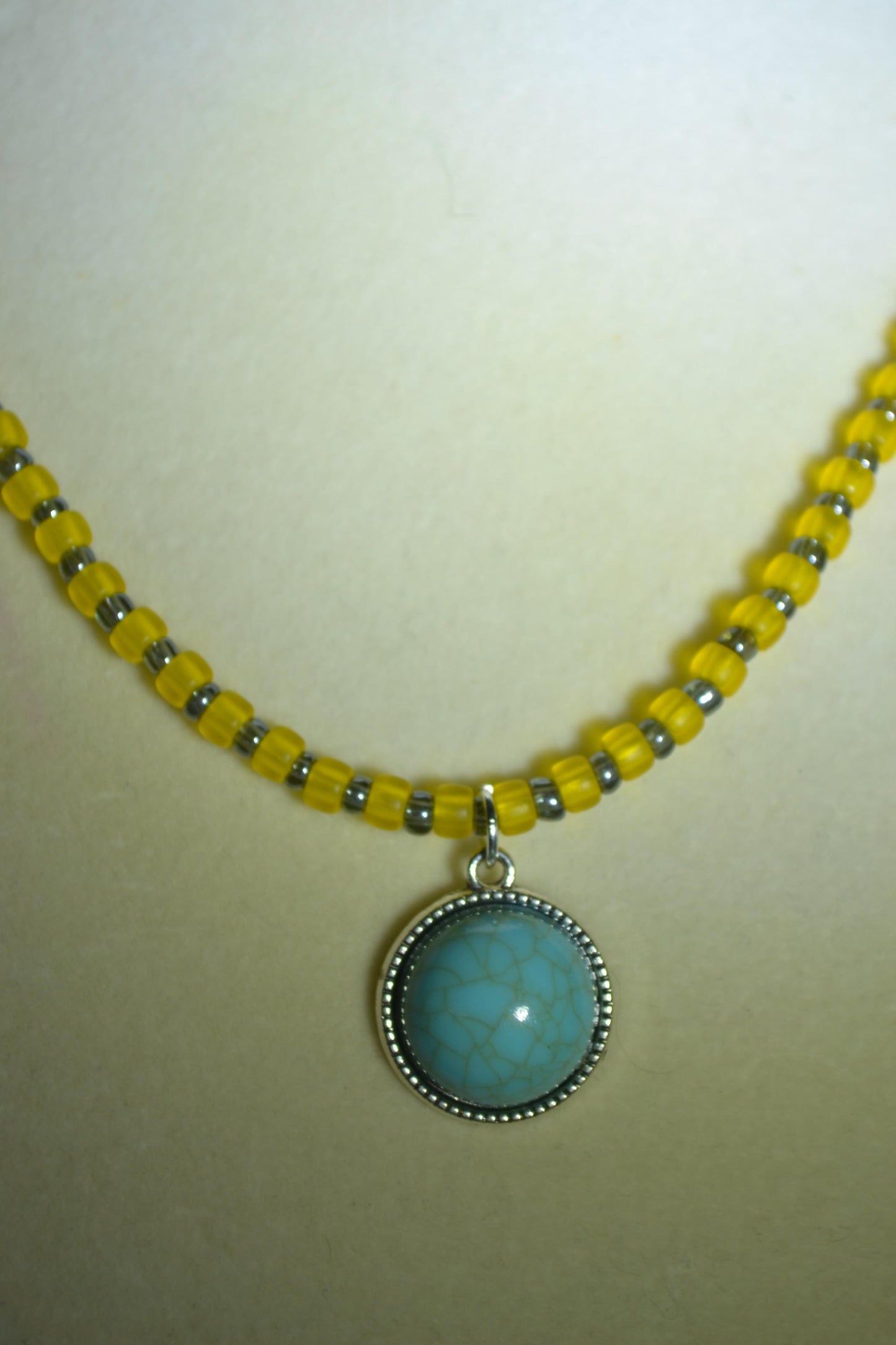 Turquoise pendant glass bead necklace. Yellow and grey