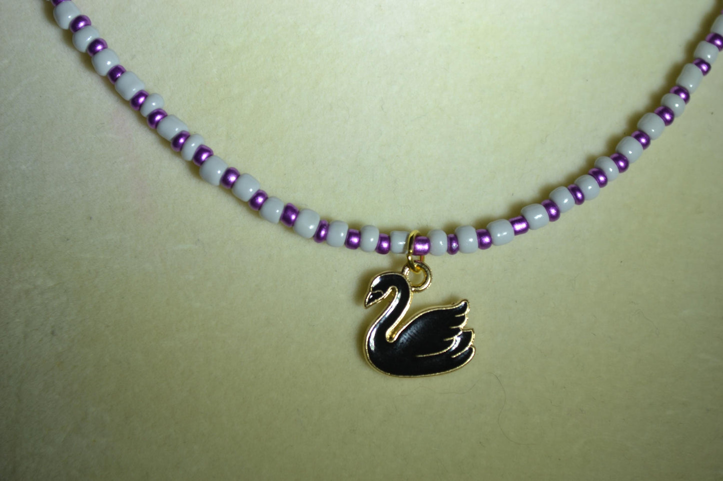 Black Swan pendant glass bead necklace. Grey and purple