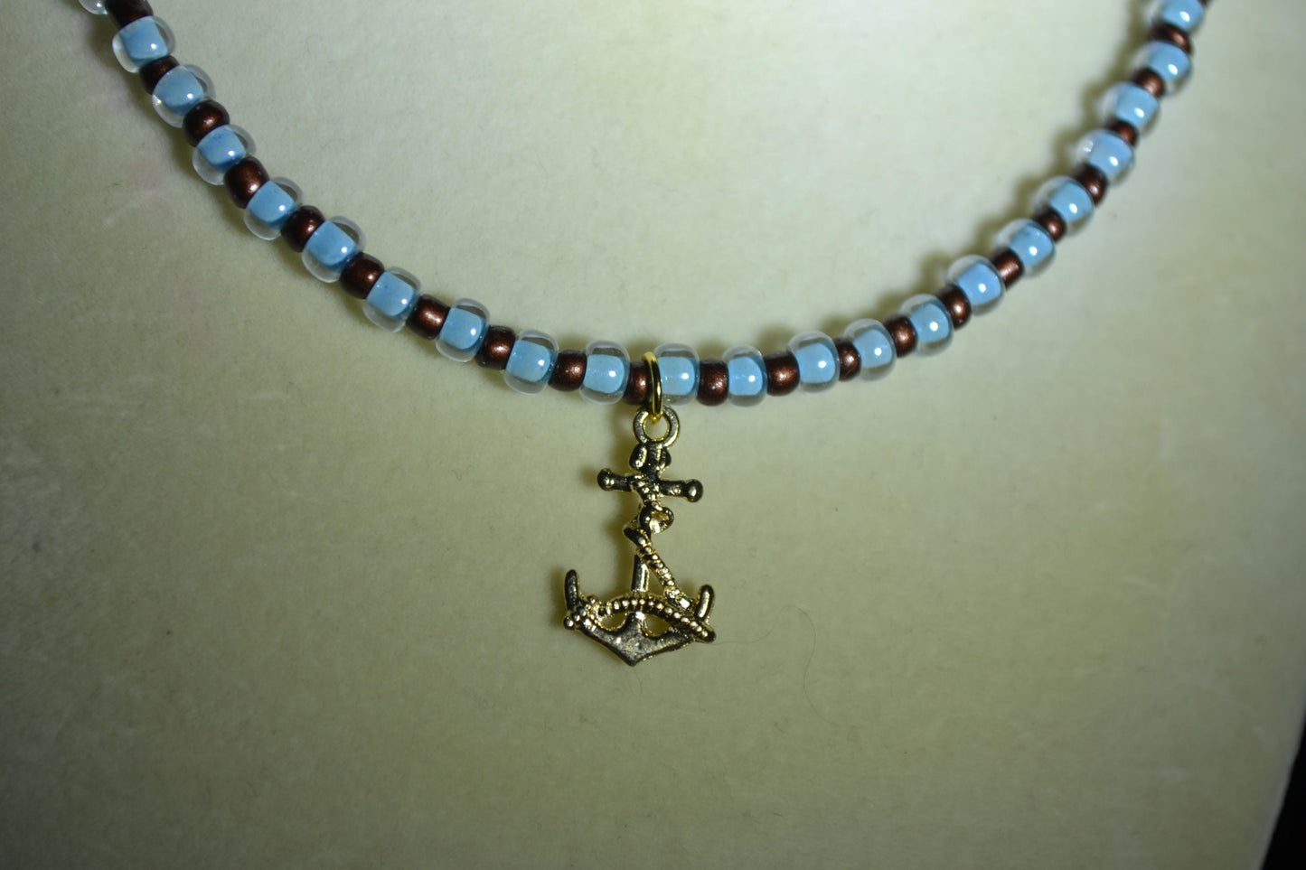 Anchor pendant glass bead necklace. Blue and brown