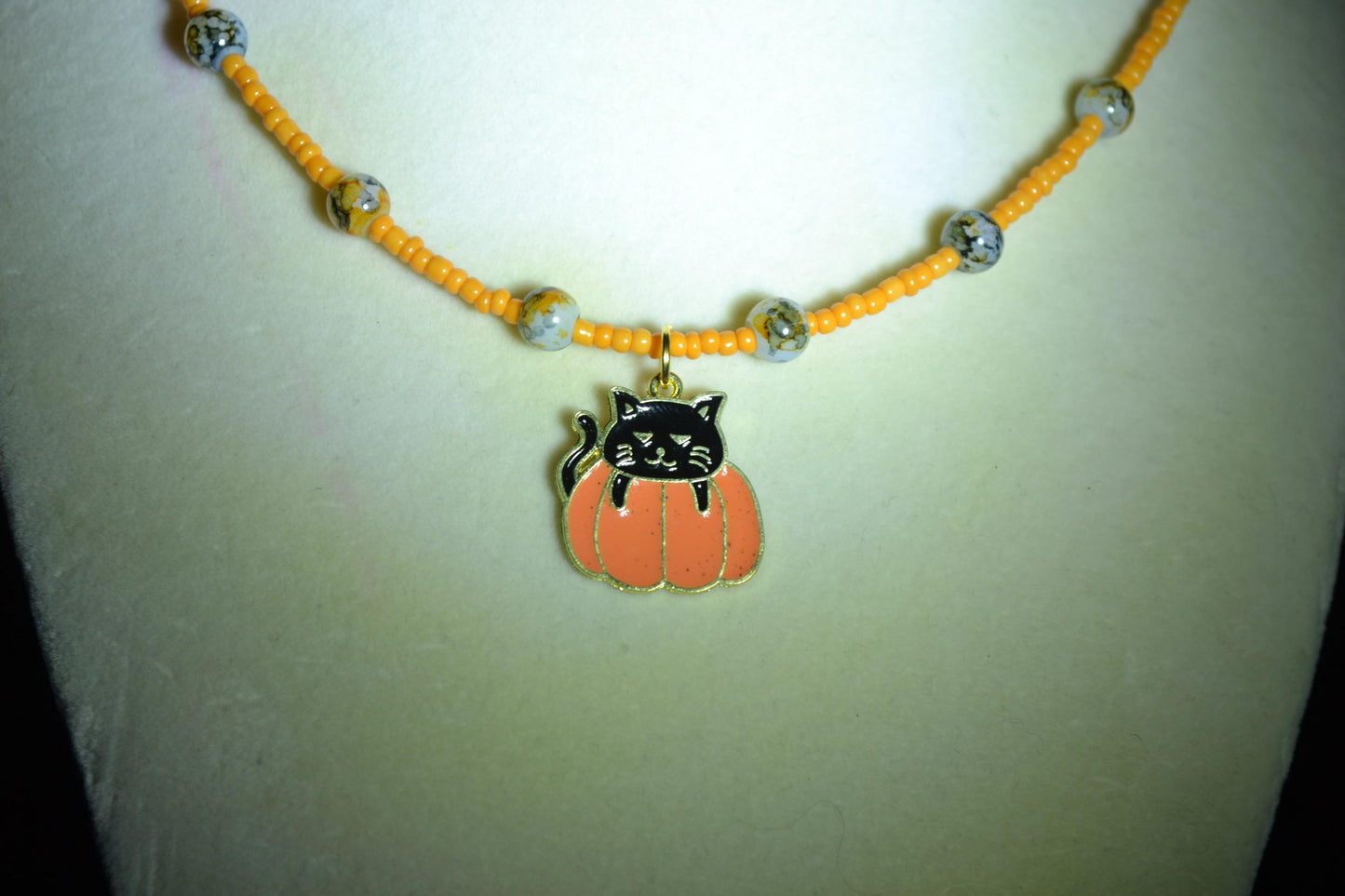 Black cat in pumpkin pendant glass bead choker. Orange and black
