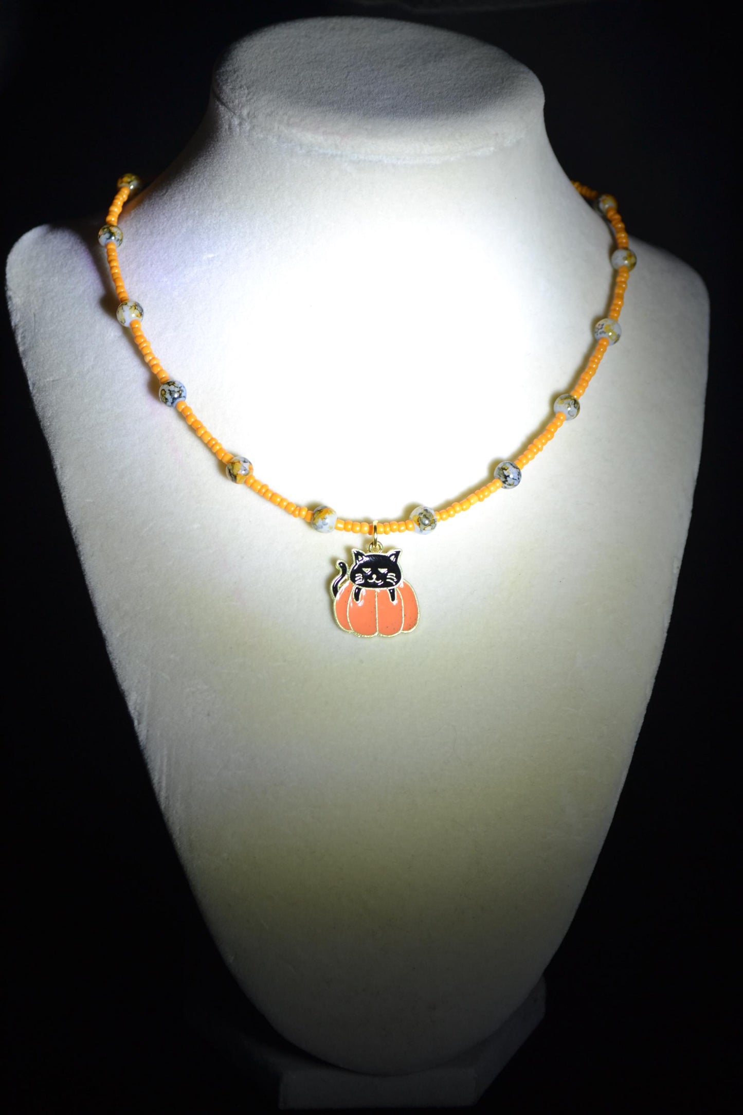 Black cat in pumpkin pendant glass bead choker. Orange and black