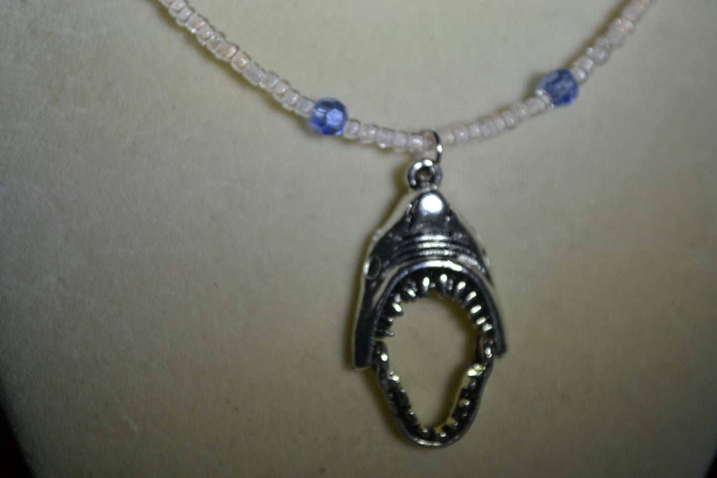 Shark jaws pendant glass bead necklace. Blue and white