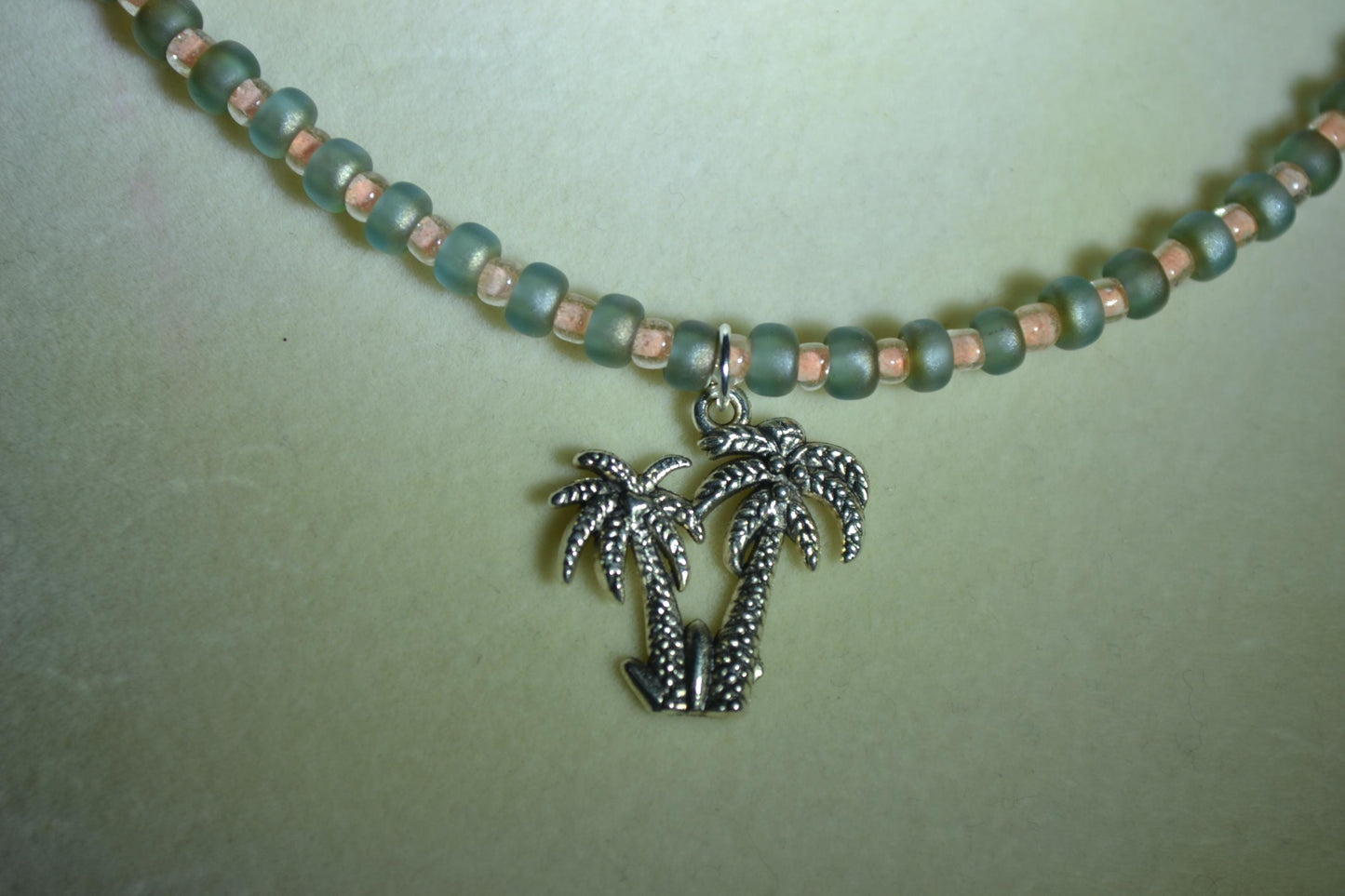 Palm trees pendant glass bead necklace. Coral and matte green