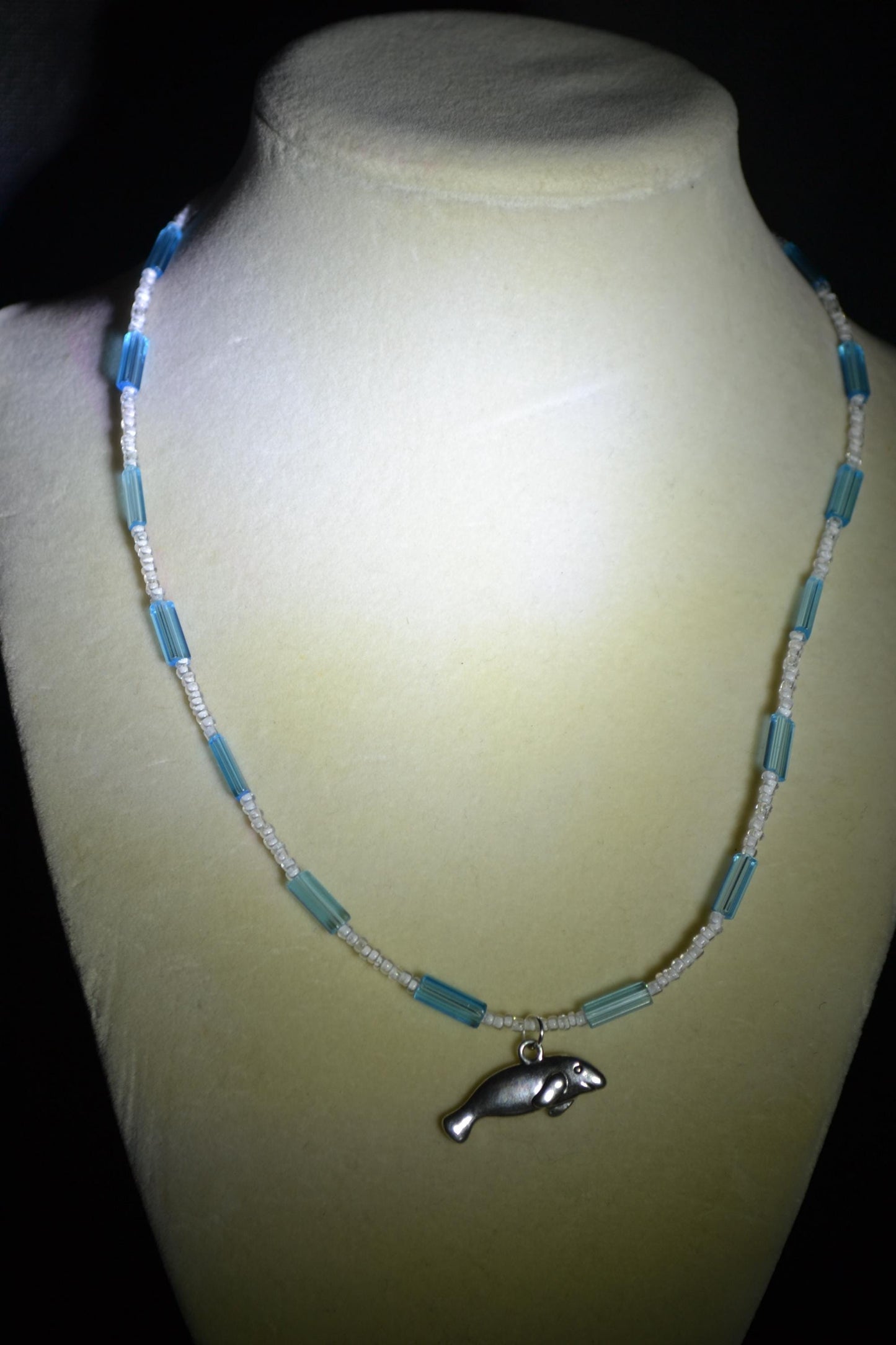 Manatee pendant glass bead necklace. Blue and white