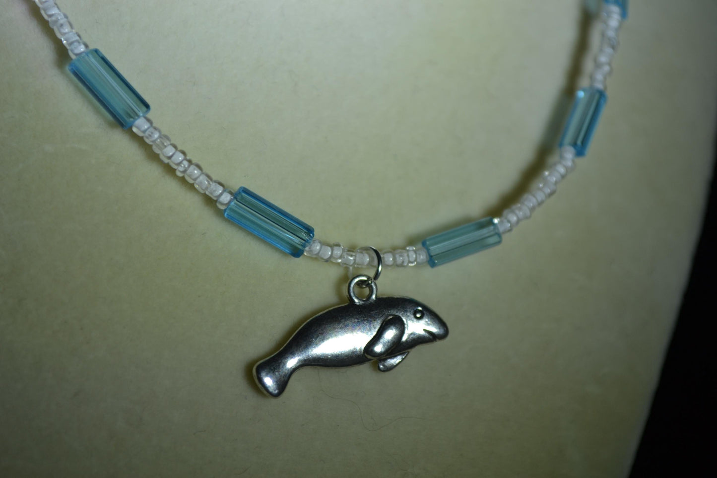 Manatee pendant glass bead necklace. Blue and white
