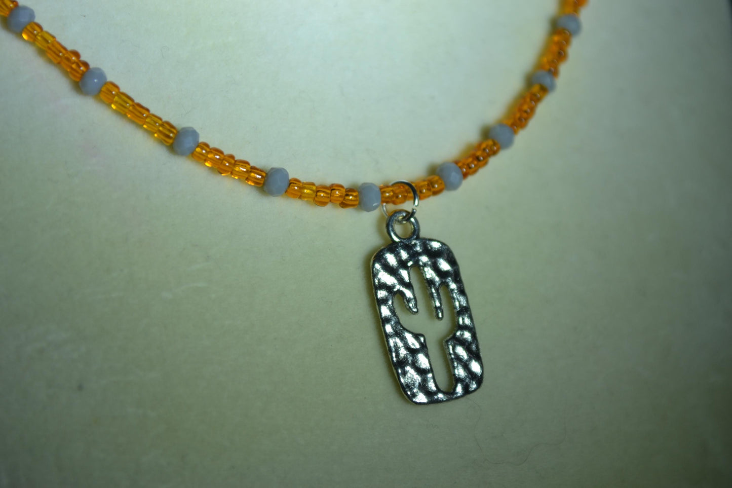 Hammered Cactus pendant glass bead necklace. Orange and grey