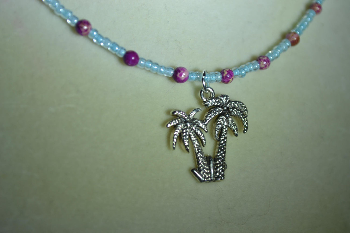 Palm Trees pendant glass bead necklace. Blue and purple