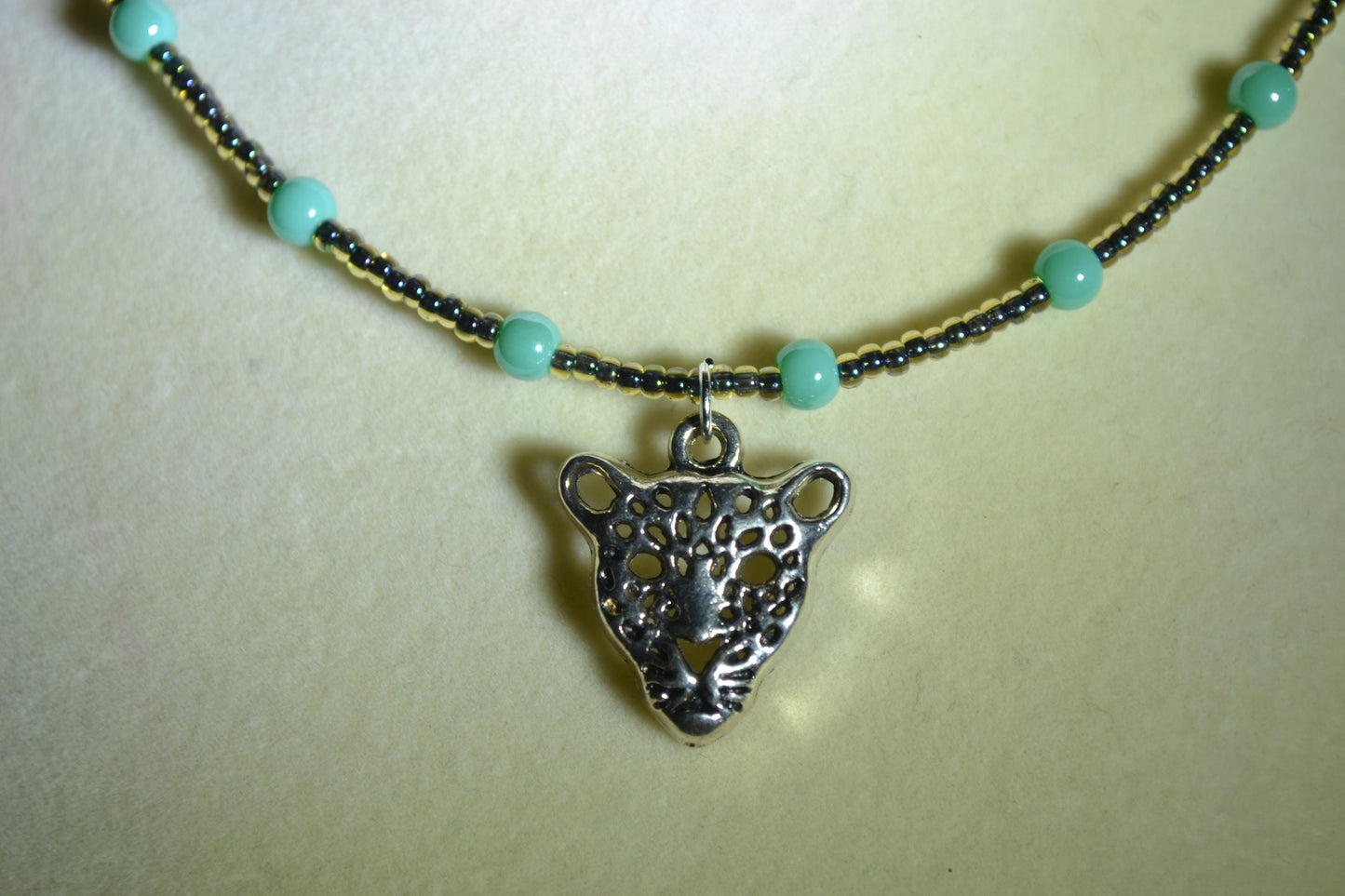 Jaguar pendant glass bead necklace. Teal and black
