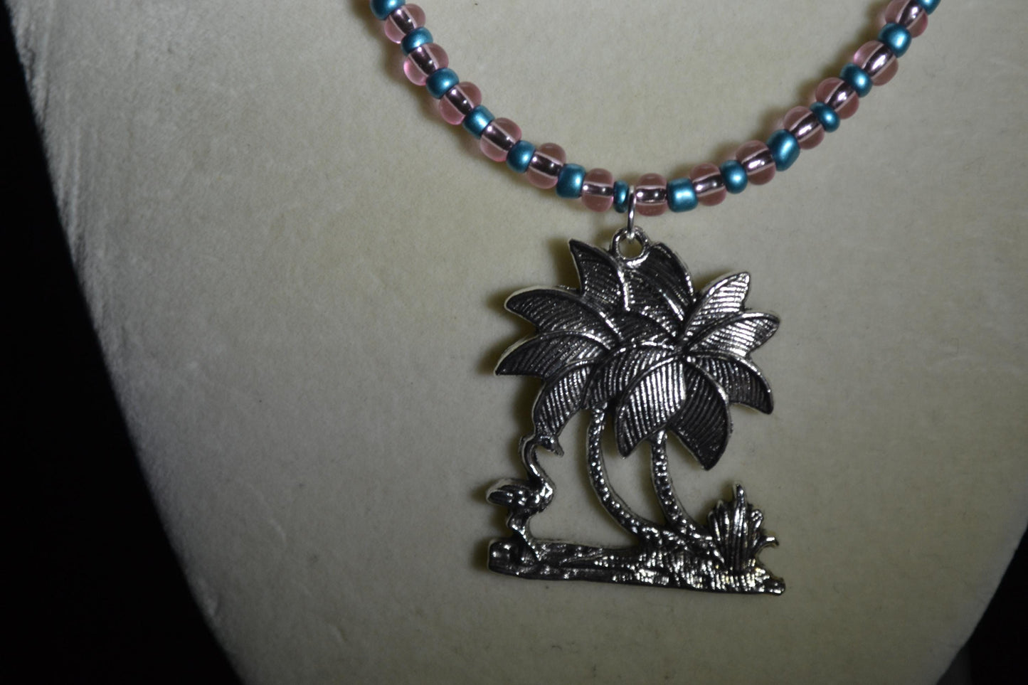 Palm Tree and Flamingo pendant glass bead necklace. Metallic blue and pink