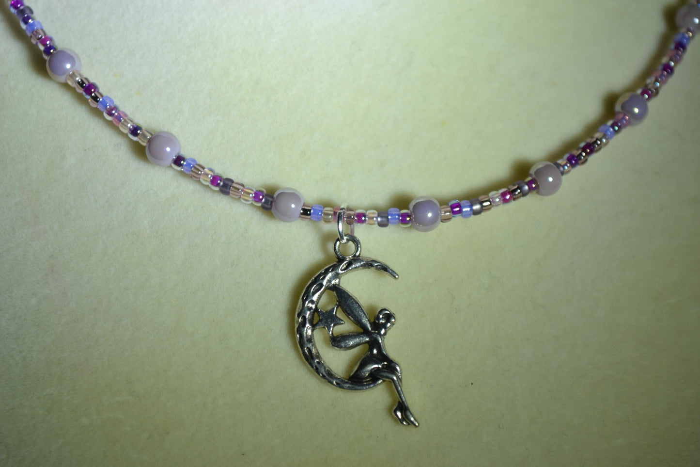Fairy pendant glass bead necklace. Mixed purples