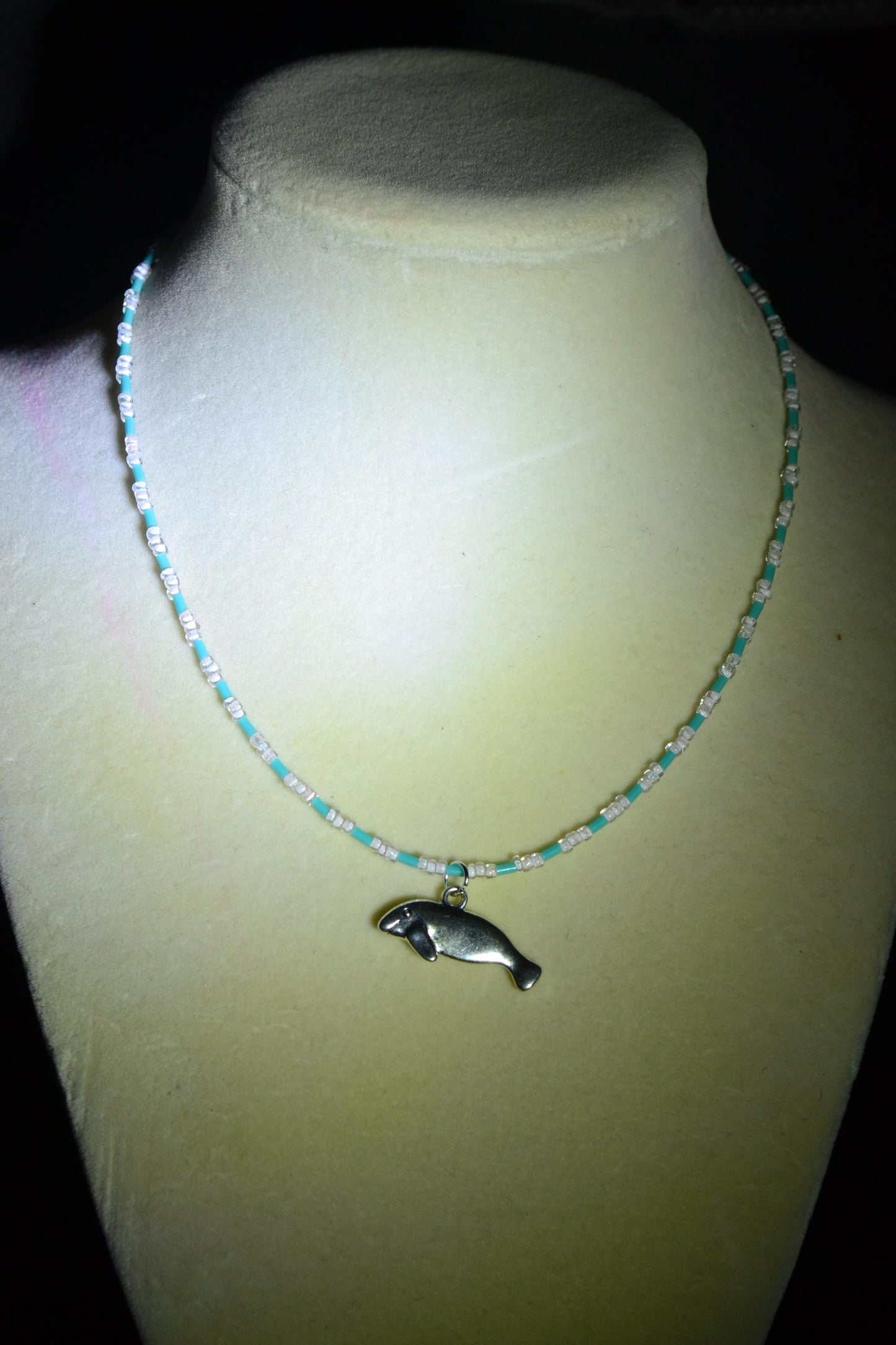 Manatee pendant glass bead necklace. Blue and white